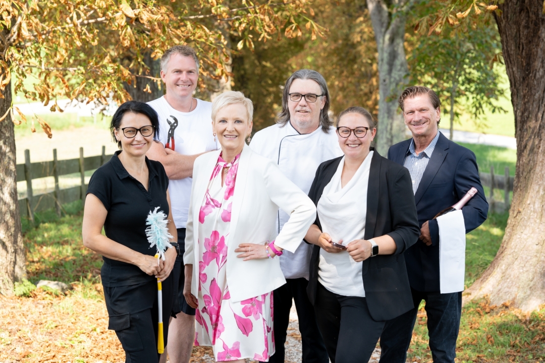 Photo of the department head team including the director in a tree-lined avenue